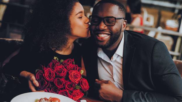 a happy couple is on a romantic date in a restaurant